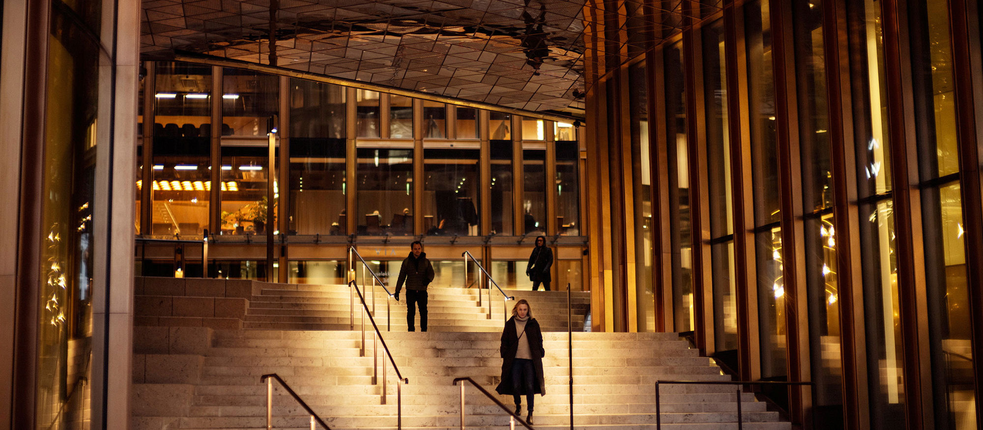 Staircase under the roof of a large office building, in dim lighting. Photo.